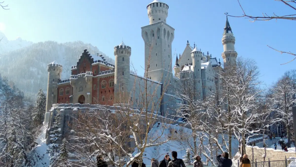 Tourists enjoying the exterior views of Neuschwanstein Castle Tourists enjoying the exterior views of Neuschwanstein Castle