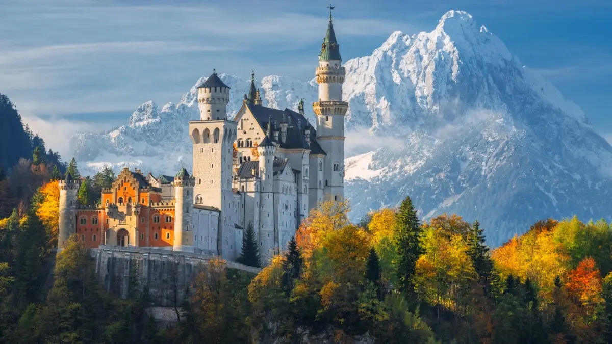 Neuschwanstein Castle with the beautiful backdrop of snowy alpine mountains